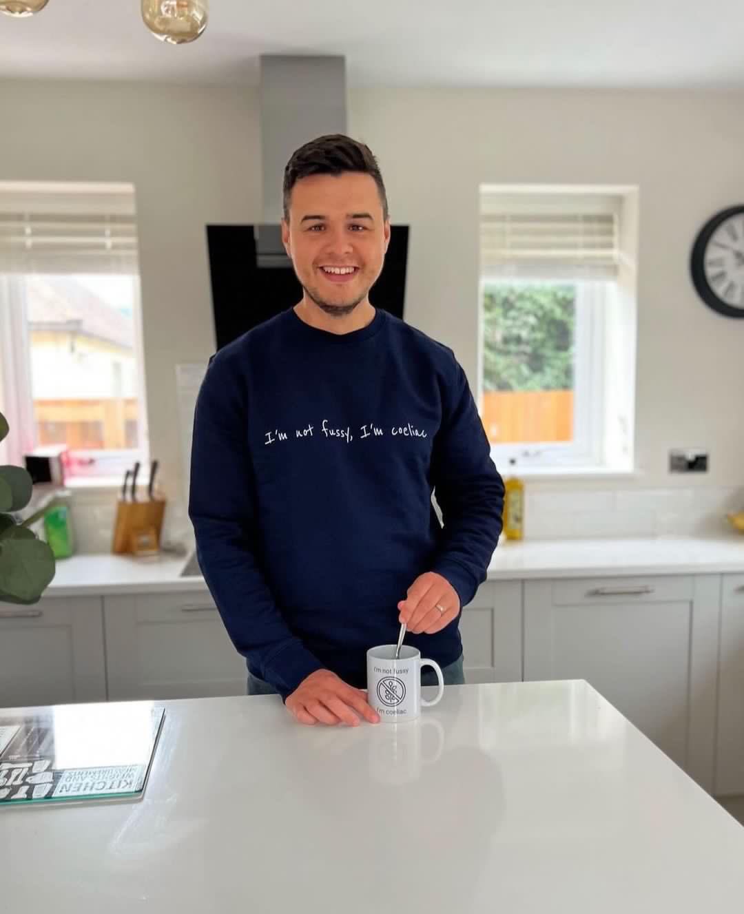 Geraint Evans wearing a sweater saying, 'I'm not fussy I'm coeliac.'